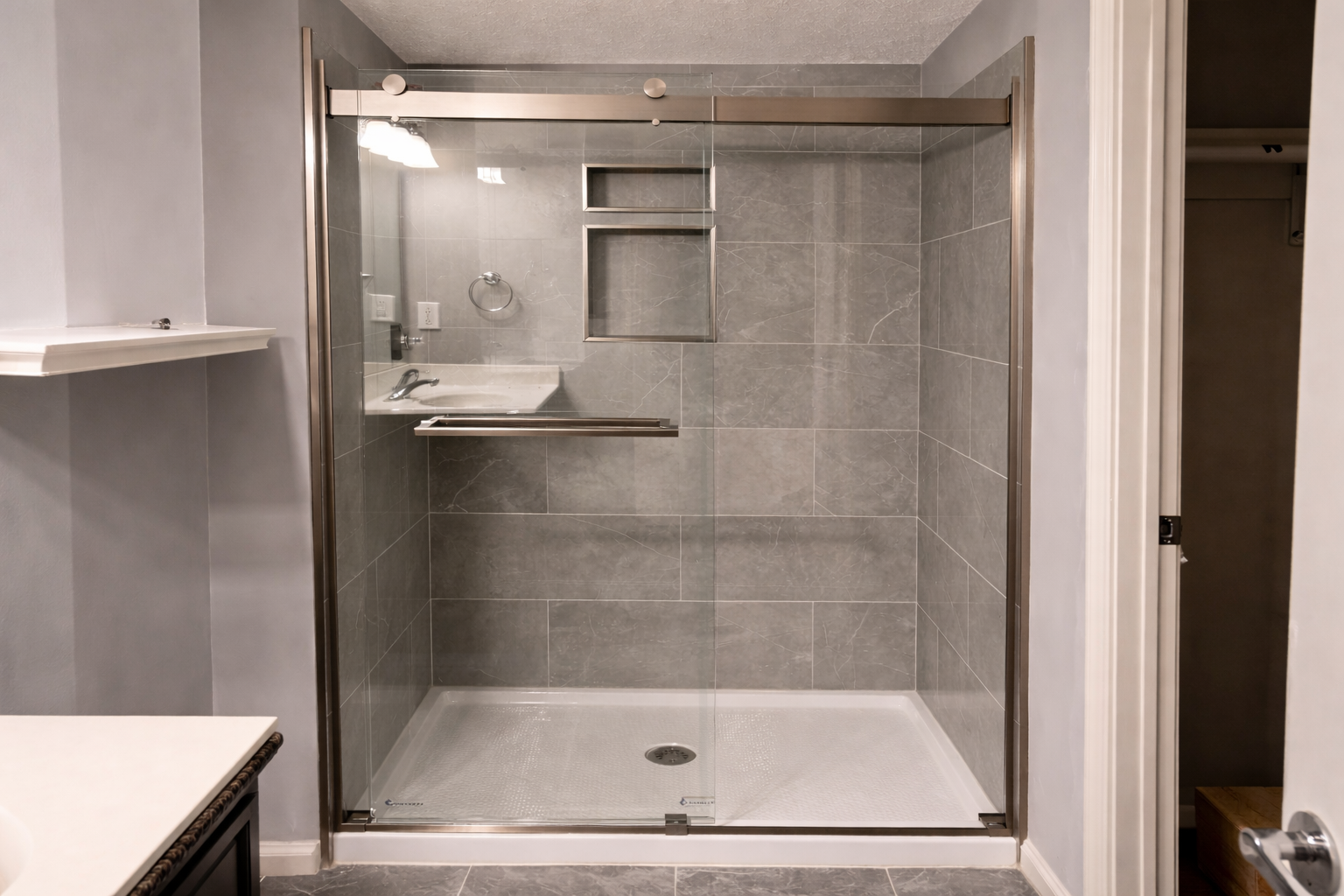 shower fully finished with grey marble-look porcelain tile on all walls