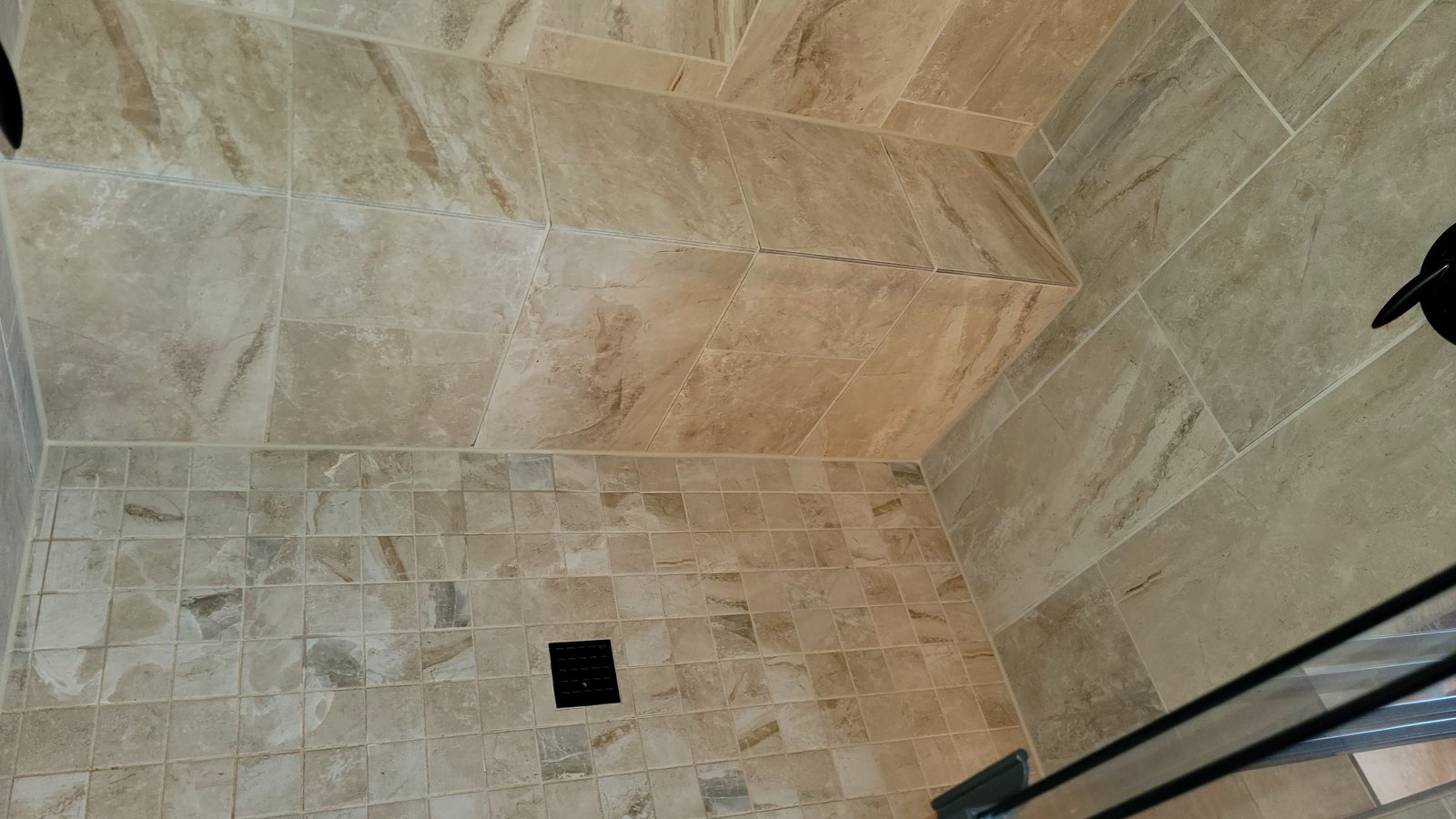 Kansas City travertine shower after professional grout cleaning and sealing with the grout back to an even color